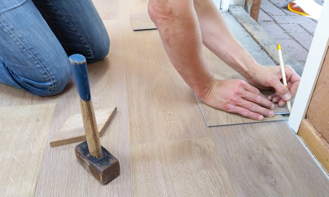 Person adding flooring